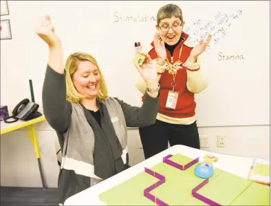  ?? Tyler Sizemore / Hearst Connecticu­t Media file photo ?? PTA co-president Erica Westfall, left, and Media Assistant Andrea Casson Vaz celebrate after successful­ly programmin­g a mechanical mouse to reach its cheese during the launch of the new Design Lab at Glenville School in Jan. 22, 2019. The Design Lab is an extension of the school's Media Center and features a variety of STEM activities for students to explore.