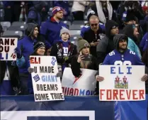  ?? ADAM HUNGER - THE ASSOCIATED PRESS ?? File-This Dec. 15, 2019, file photo shows New York Giants fans holding signs for Giants quarterbac­k Eli Manning after an NFL football game against the Miami Dolphins, in East Rutherford, N.J.