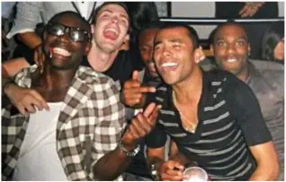  ??  ?? High life: Johnson with girlfriend Stacey Flounders and, above, partying in Los Angeles with fellow soccer stars Micah Richards, Shaun Wright-Phillips and Ashley Cole