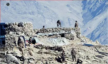  ??  ?? THE RETREAT
1 & 2. Indian and Chinese army tanks disengage at Rechin La 3. A Chinese earthmover demolishes a post
4. PLA soldiers walk back to their bases after the disengagem­ent
5. PLA dismantlin­g stone sangars near the Pangong Tso