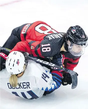  ?? LIAM RICHARDS/THE CANADIAN PRESS ?? Halli Krzyzaniak knocks U.S. forward Brianna Decker to the ice during 2018 Four Nations Cup action in Saskatoon on Wednesday. Team Canada head coach Perry Pearn doesn’t think full-out body checking is coming in any time soon.