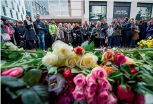 ?? AFP ?? People react during a minute of silence to commemorat­e the victims of Friday’s terror attack at a makeshift memorial in Stockholm, Sweden, on Monday. —