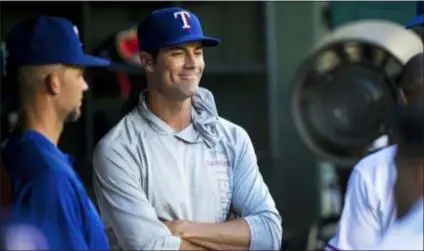  ?? ASHLEY LANDIS — THE DALLAS MORNING NEWS VIA AP ?? Pitcher Cole Hamels smiles as he talks to his Rangers teammates in the dugout on Thursday in Arlington, Texas.