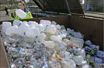  ??  ?? In this March 12 file photo, Skagit County Solid Waste Division manager Margo Gillaspy displays some of the recyclable plastic items that had been deposited at the Skagit County Transfer Station at Ovenell Road in Mt. Vernon, Wash. SCOTT TERRELL/SKAGIT...