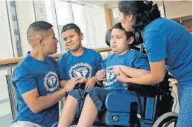  ?? [KATHERINE C. COHEN/BOSTON CHILDREN’S HOSPITAL VIA THE ASSOCIATED PRESS] ?? Paul and Liliana Rojas speak to their sons, Brian, second from left, and Brandon, on Aug. 29 at Boston Children’s Hospital. The young boys suffer from adrenoleuk­odystrophy, an inherited nerve disease featured in the movie “Lorenzo’s Oil.”