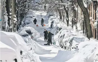  ?? AP ?? Bostonians on Sunday attempted to unearth their cars from the two feet of snow that fell Friday and Saturday.