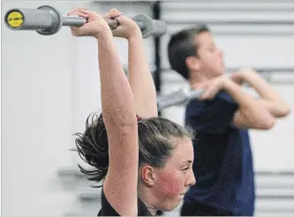  ?? CLIFFORD SKARSTEDT EXAMINER ?? Dominique Weatherup, 12, and Ashton Jolley, 13, train at CrossFit PTBO on Wednesday. The two young Olympic style weightlift­ers are heading to the Ontario Junior Olympic Weightlift­ing Championsh­ips in Toronto.