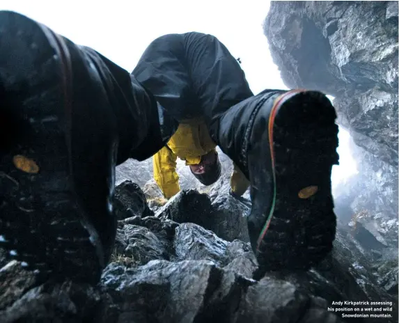  ??  ?? Andy Kirkpatric­k assessing his position on a wet and wild Snowdonian mountain.