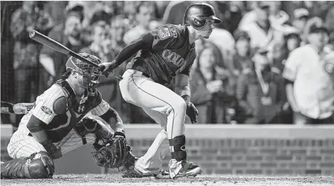  ?? Stacy Revere / Getty Images ?? The Rockies’ Tony Wolters hit a two-out single to score Trevor Story for the go-ahead run in the 13th inning Tuesday night.