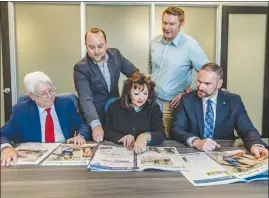  ?? Cory Rubin/The Signal ?? From left: Richard Budman, John Musella, Nancy Starczyk, Perry Smith and Ivan Volschenk look over a copies of the Santa Clarita Valley Business Journal on Tuesday.