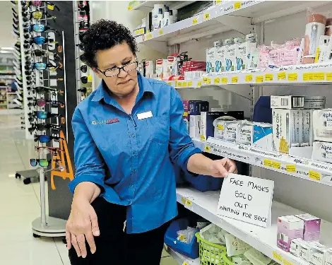  ?? Picture: WERNER HILLS ?? SOLD OUT: Klinimed Pharmacy stock assistant Veronica Niekerk at an empty shelf where face masks were kept in the Newton Park store. Gloves, goggles and thermomete­rs were also selling out fast after the first coronaviru­s case in SA was confirmed