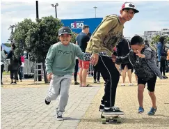  ?? Picture: EUGENE COETZEE ?? HOLIDAY FUN: M Zuhayr Peterson, 5, left, Ganief Salie, 12, and Yaeesh Salie, 8, travelled from Uitenhage to watch the 5150 Triathlon at Kings Beach on Sunday