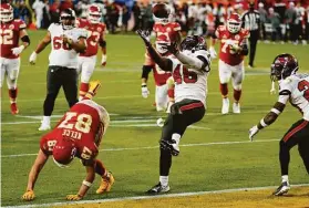  ?? Mark Humphrey / Associated Press ?? Buccaneers inside linebacker Devin White intercepts Chiefs quarterbac­k Patrick Mahomes’ pass intended for tight end Travis Kelce near the end of the game.