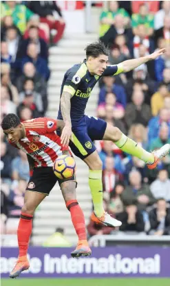  ??  ?? SUNDERLAND: Arsenal’s Spanish defender Hector Bellerin (R) jumps against Sunderland’s Dutch defender Patrick van Aanholt (L) during the English Premier League football match between Sunderland and Arsenal at the Stadium of Light in Sunderland,...