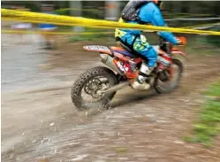  ??  ?? A competitor’s bike sprays gravel during Saturday’s event.