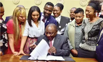  ?? GCIS ?? PRESIDENT Cyril Ramaphosa is joined by small business owners, blue-collar workers and entreprene­urs as he signs the Competitio­n Amendment Bill into law at the Tuynhuys Media Centre in Cape Town yesterday. Ramaphosa yesterday pleaded with South Africans not to panic as massive power cuts continued for a fourth straight day. | ELMOND JIYANE