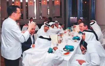  ?? Courtesy: Ministry of Climate Change and Environmen­t ?? Dr Thani Ahmad Al Zeyoudi and other officials taking part in the upcycled iftar.