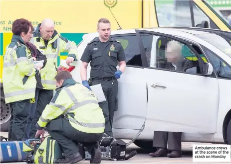  ??  ?? Ambulance crews at the scene of the crash on Monday