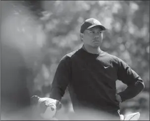  ?? The Associated Press ?? ROUGH DAY: Tiger Woods waits to hit on the fourth hole during the first round at the Masters Thursday in Augusta, Ga. Woods finished the day with a 1-over-par 73, tied for 29th in his first competitiv­e round at the course since 2015.