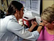  ??  ?? Shalane Lamb, RN-BSN with the Walker County Health Department, injects Cindy Gibbs, of LaFayette, an influenza shot last September. Officials say it is not too late to get such shots at local pharmacies, doctors’ offices or health department­s before...