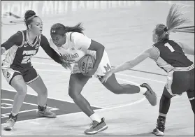  ?? Associated Press ?? To the hoop: Maryland guard Ashley Owusu (15) drives to the hoop in front of Purdue guards Kayana Traylor (23) and Karissa McLaughlin (1) Sunday in College Park, Md.