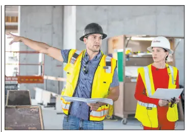  ??  ?? Loay Hanthel, left, with M.J. Dean, and Maureen Schafer with the Nevada Health Bioscience Corporatio­n give a tour of the constructi­on on Wednesday at UNLV.