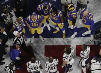  ?? ASSOCIATED PRESS ?? MAKE HEADS OR TAILS OF IT: Patriots and Rams captains watch the coin toss before the start of Super Bowl LIII in Atlanta.