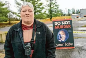  ?? Earl Neikirk/Associated Press ?? Anti-abortion activist Debra Mehaffey stands near a clinic on Feb. 23 in Bristol, Va. Residents are battling over welcoming abortion providers.