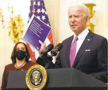  ?? ALEX WONG/GETTY ?? President Joe Biden speaks as Vice President Kamala Harris looks on during an event in the State Dining Room of the White House on Thursday in Washington, D.C. Biden delivered remarks on his administra­tion’s COVID-19 response, and signed executive orders and other presidenti­al actions.