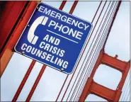  ?? ?? A crisis counseling sign is seen on the Golden Gate Bridge in San Francisco. Starting in July, callers in crisis will dial 988 to reach the National Suicide Prevention Lifeline, making it much easier than dialing the current 10-digit number.