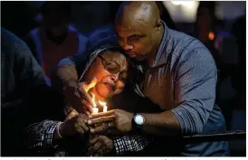  ?? NICK WAGNER / AMERICAN-STATESMAN ?? David Johns comforts his sister, Janet Harris, during a vigil for her daughter, Ebony Sheppard, in Austin on Dec. 30. Sheppard was killed Dec. 26 in a robbery attempt. Xavier O’Neil Lewis has been charged with capital murder and other charges stemming...