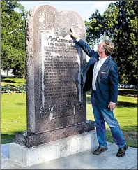  ?? Arkansas Democrat-Gazette/JEFF MITCHELL ?? Scott Stewart, a senior pastor at the Agape Church in west Little Rock, checks out the Ten Commandmen­ts monument Tuesday on the state Capitol grounds. The design was taken from the tablet in Cecil B. DeMille’s 1956 film of the same name.