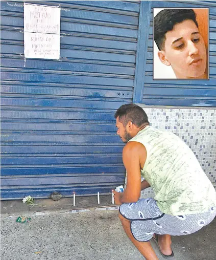  ?? SEVERINO SILVA ?? Amigos acenderam velas na porta do mercado onde Matheus (no detalhe) morreu, em Guaratiba