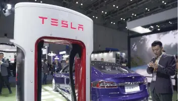  ?? — Reuters ?? A Tesla sign is seen during the China Internatio­nal Import Expo (CIIE), at the National Exhibition and Convention Center in Shanghai, China.