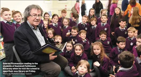  ?? Photo by Michelle Cooper Galvin ?? Gabriel Fitzmauric­e reading to the students of Gaelscoil Faithleann Killarney when he visit the school to open their new library on Friday.