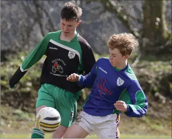  ??  ?? Lewis McComiskey of Cloughbawn in tackled by Mark Shortall (Glynn Barntown) in their Under-16 tie.