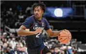  ?? Nick Wass/Associated Press ?? UConn’s Tristen Newton dribbles the ball during the first half against Georgetown on Saturday.