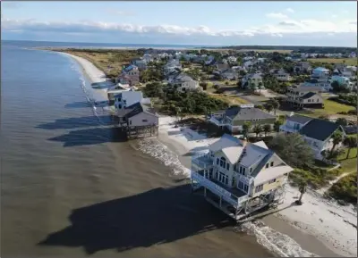  ?? (AP/Rebecca Blackwell) ?? Water laps the bottom level of four homes Oct. 30 in Harbor Island, S.C. The homes had to be abandoned after years of beach erosion and damage from Hurricane Matthew in 2016.