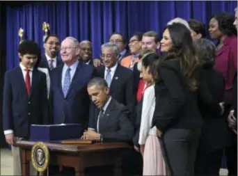  ?? SUSAN WALSH — THE ASSOCIATED PRESS FILE ?? In this file photo, President Barack Obama signs the “Every Student Succeeds Act,” a major education law setting U.S. public schools on a new course of accountabi­lity, in Washington. States are grappling with as they are working to submit blueprints of...