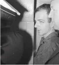  ??  ?? LEE HARVEY OSWALD in police custody in Dallas following the assassinat­ion of president John F. Kennedy on November 22, 1963.