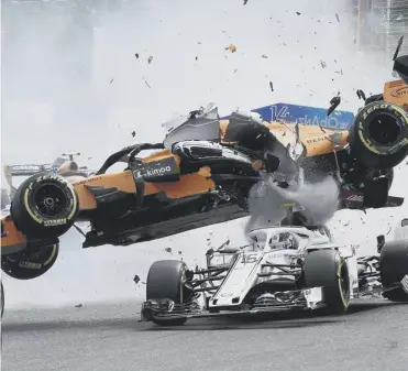  ??  ?? 0 Fernando Alonso’s Mercedes crashes on to the top of Charles Leclerc’s Sauber after being struck by the Renault of Nico Hulkenberg during the first lap of the Belgian Grand Prix.2 Race winner Sebastian Vettel celebrates on the podium.