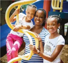  ??  ?? Parkland patient Shalundria Bell, center, was first diagnosed with triple-negative breast cancer at age 30. The aggressive form of cancer is more likely to be diagnosed in younger African-Americans and Latinas.