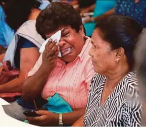  ?? AP PIC ?? A relative of a crew member in a ship that was captured by Somali pirates on Monday crying during a meeting with Sri Lankan shipping authoritie­s in Colombo on Thursday. The pirates have released the ship and its crew.