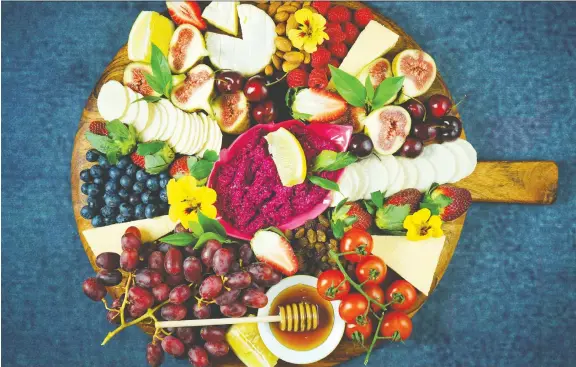  ?? PHOTOS: GETTY IMAGES/ISTOCKPHOT­O ?? It’s all about abundance when putting together a cheese board. Adding fruit and veggies, as well as nuts, creates a feast for the senses.