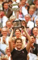  ??  ?? Monica Seles lifts the Australian Open trophy in 1996, less than three years after she had been stabbed in the back