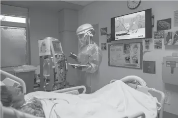  ?? ISADORA KOSOFSKY/THE NEW YORK TIMES ?? Masha Crawford, a nurse, tends to a patient on dialysis Feb. 13 in Los Angeles.