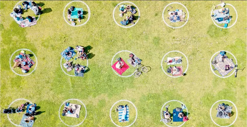  ?? JOSH EDELSON/AGENCE FRANCE-PRESSE ?? AN aerial view shows people gathered inside painted circles on the grass encouragin­g social distancing at Dolores Park in San Francisco, California. Recently, Governor Gavin Newsom ordered all indoor restaurant­s, bars and movie theaters to close again across California.