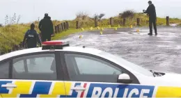  ?? ALAN GIBSON / NEW ZEALAND HERALD / THE CANADIAN PRESS / AP ?? Police collect and photograph evidence in the parking lot of the Te Toto Gorge lookout on Whaanga Road, south of Raglan, New Zealand, on Friday. A manhunt was underway after an Australian tourist was killed following what police believe was a random attack on the van that he and his partner were sleeping inside. Police say a Canadian woman is “shocked and distressed” after her Australian fiancé was murdered in an
apparently random attack.