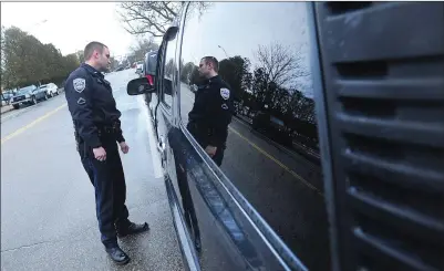  ?? Ernest A. Brown photos ?? Woonsocket Police Officer Michael Martinsen, pictured during a routine traffic stop recently, is certified as a Drug Recognitio­n Expert, one of two on the Woonsocket force. Statewide, only about 80 police officers are recognized as DREs, but many local department­s are trying to train more.