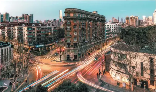  ?? PHOTOS PROVIDED TO CHINA DAILY ?? Wukang Building (center) at the junction of Huaihai Middle Road and Wukang Road is one of the most celebrated historical landmarks of Shanghai.